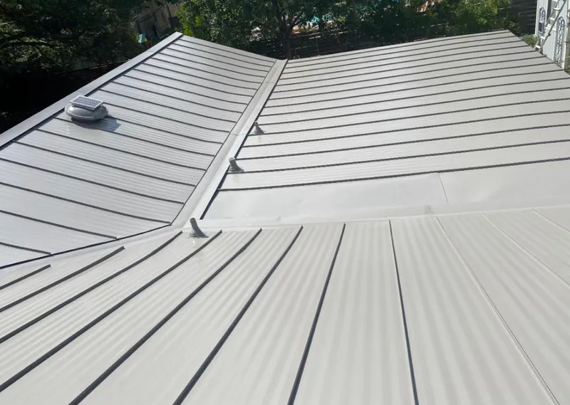 Solar attic fan installed on a metal roof for Roof Ventilation in Bern